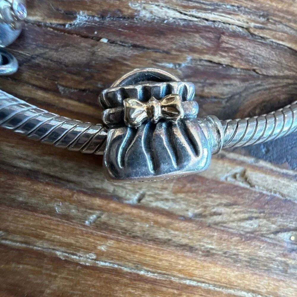 Genuine Pandora Silver (925) Bow Purse Clutch Charm also has 14k accents